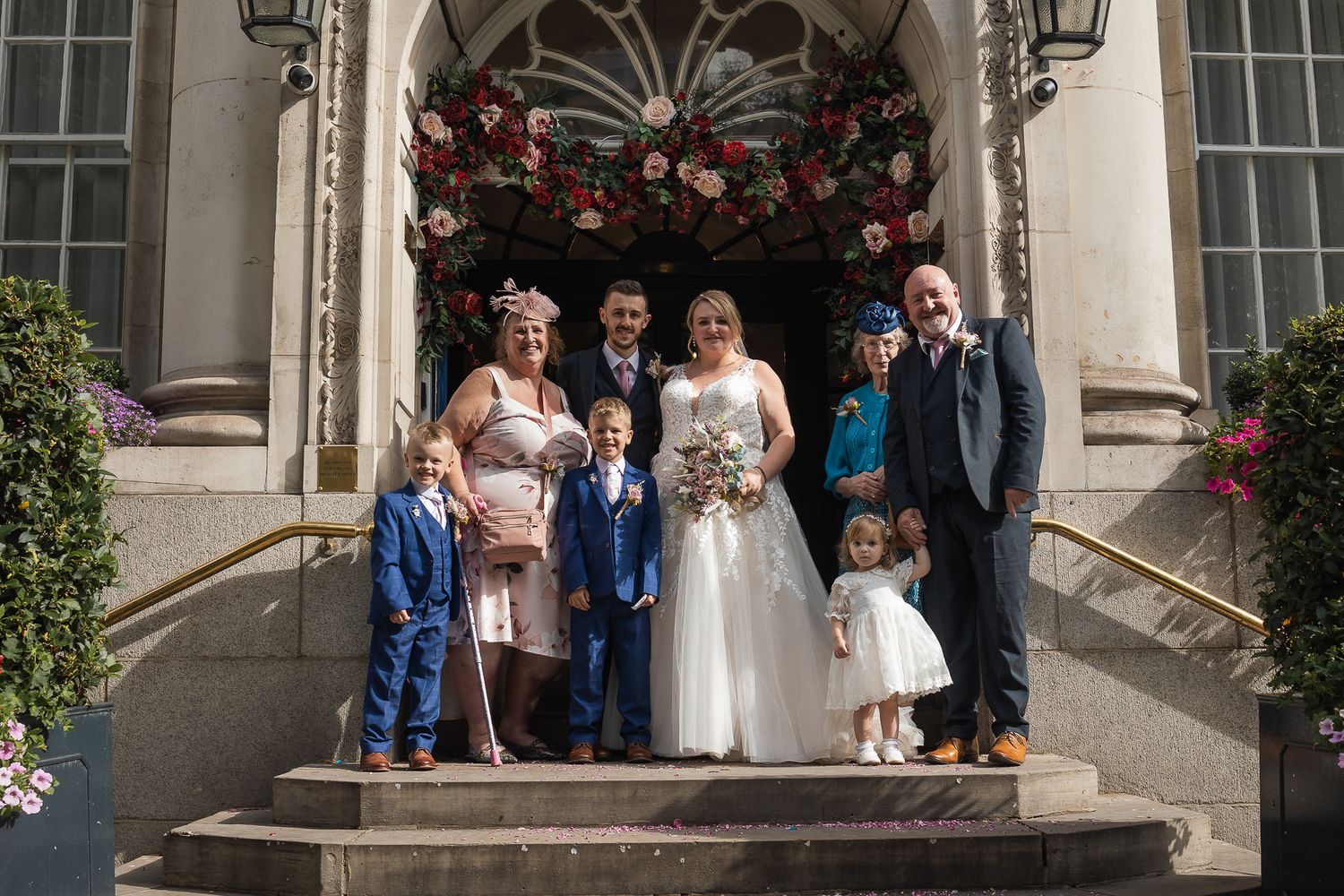 Group shot of wedding party in front of the infamous steps of Chelsea Old Town Hall