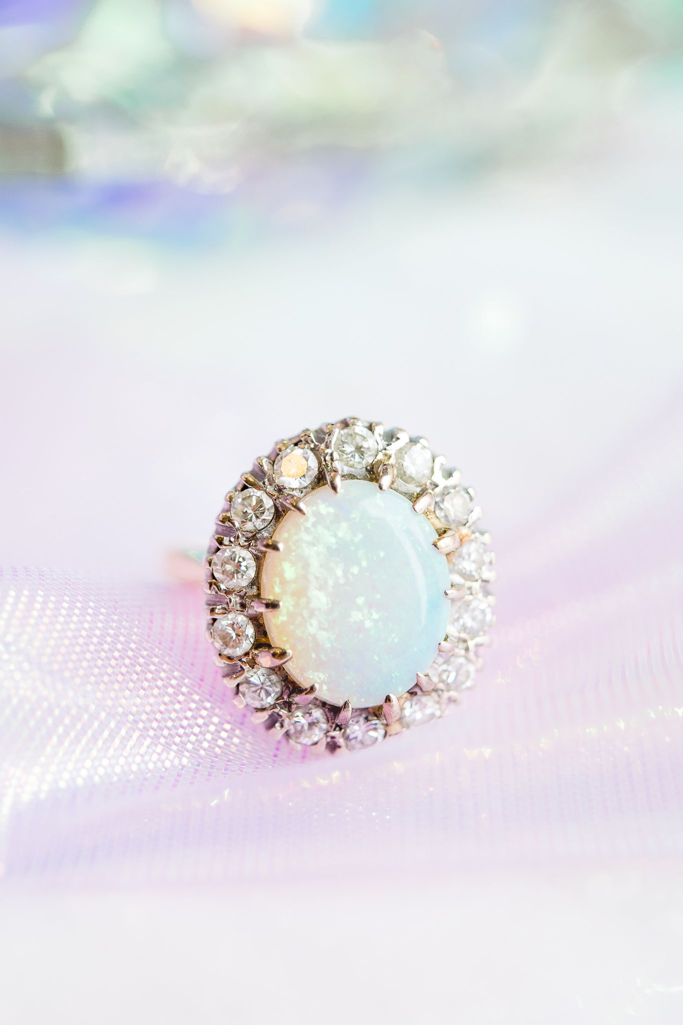 opal engagement ring on top of iridescent ribbon
