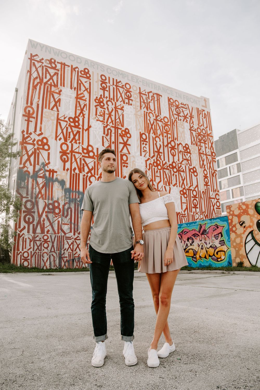 couple holding hands in a parking lot during their adventurous couples session