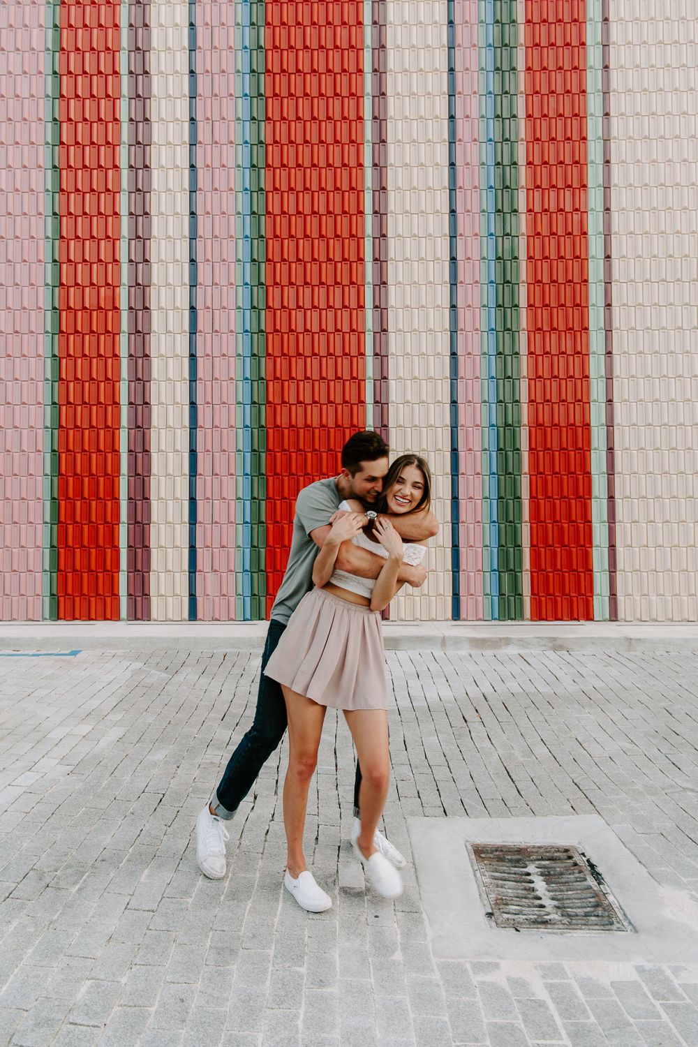 couple bear hugs during their south Florida engagement