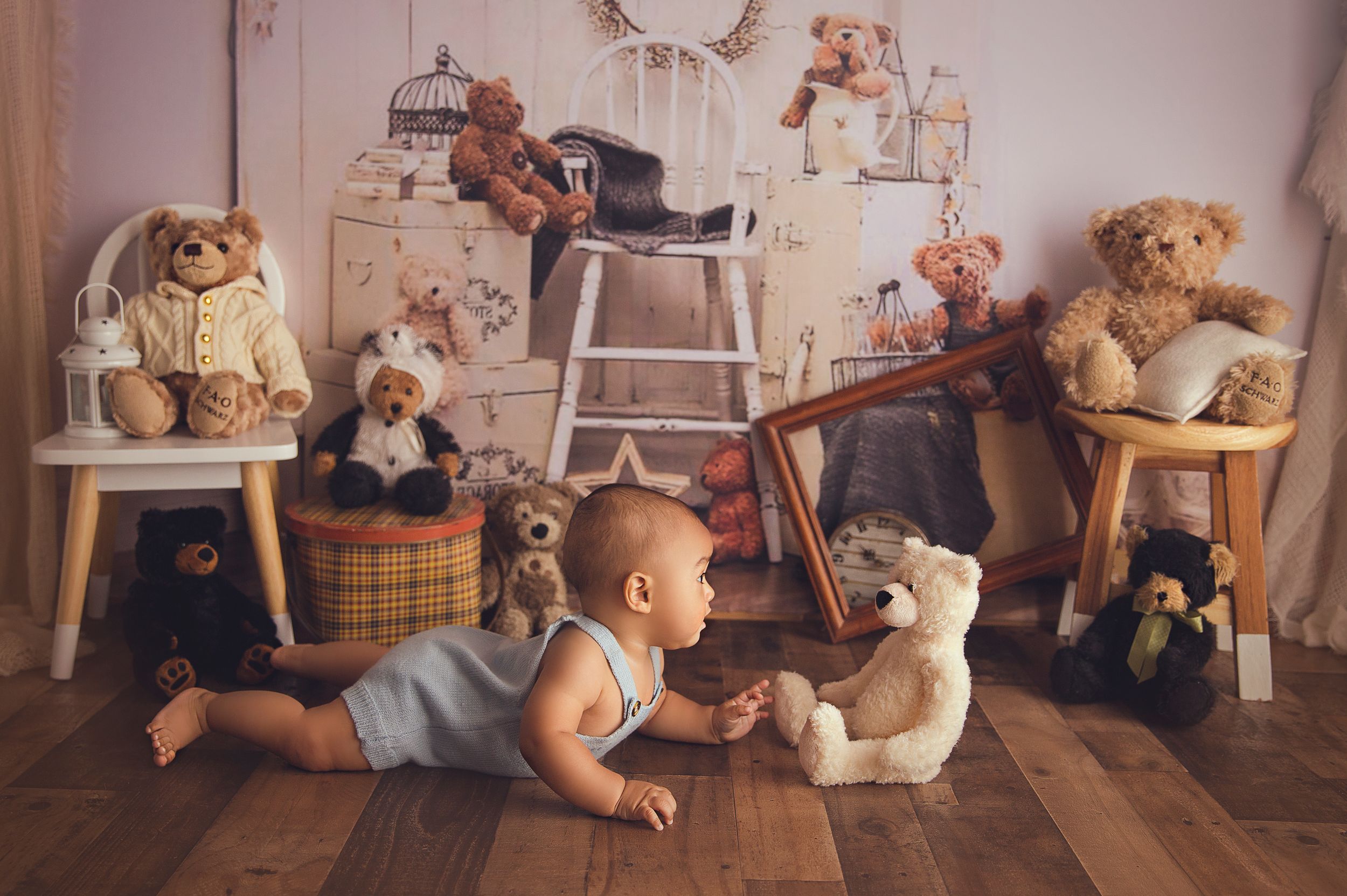 baby on tummy time looking at teddy bear