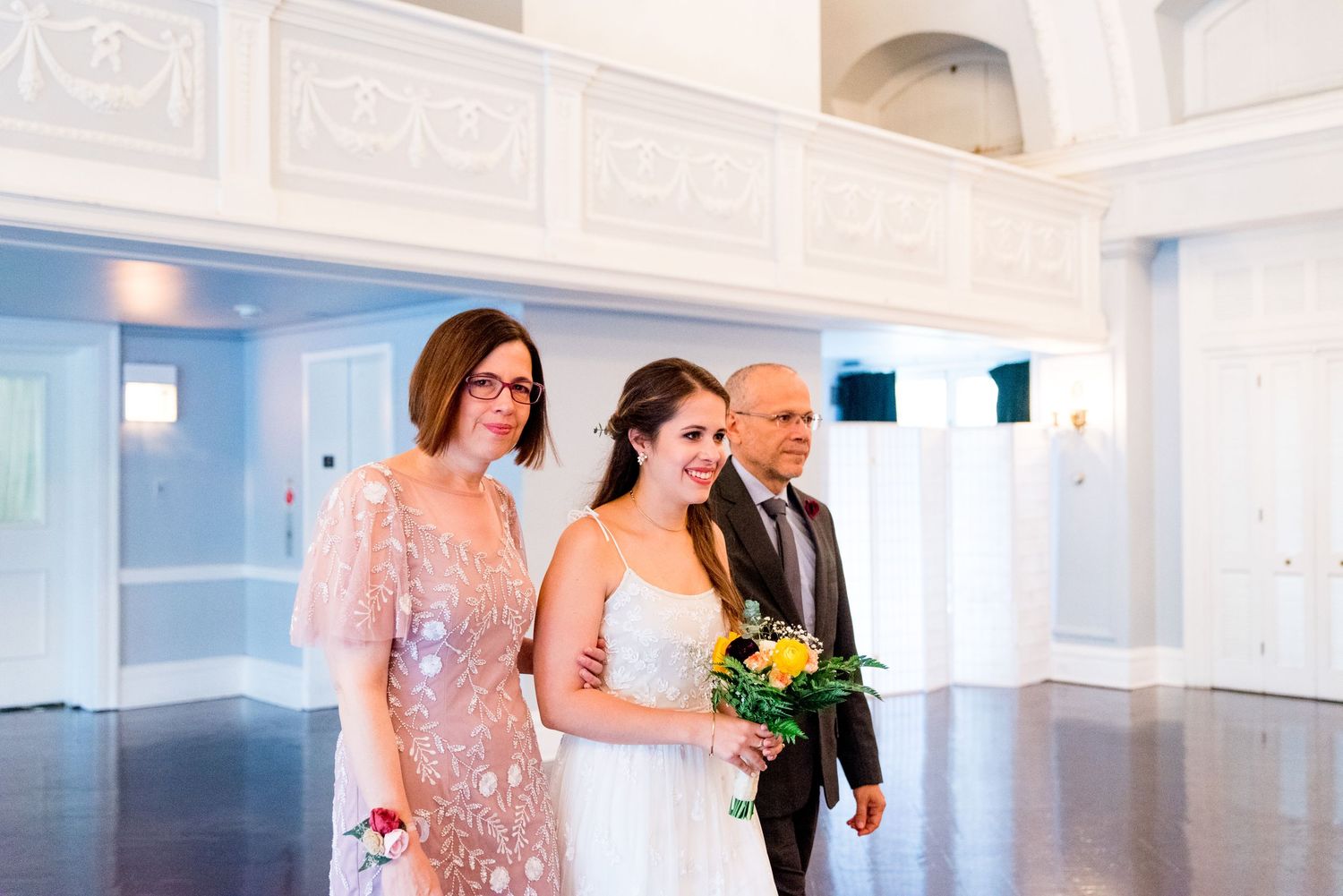 parents of the bride walk her down the aisle at the Woman's Club of Evanston