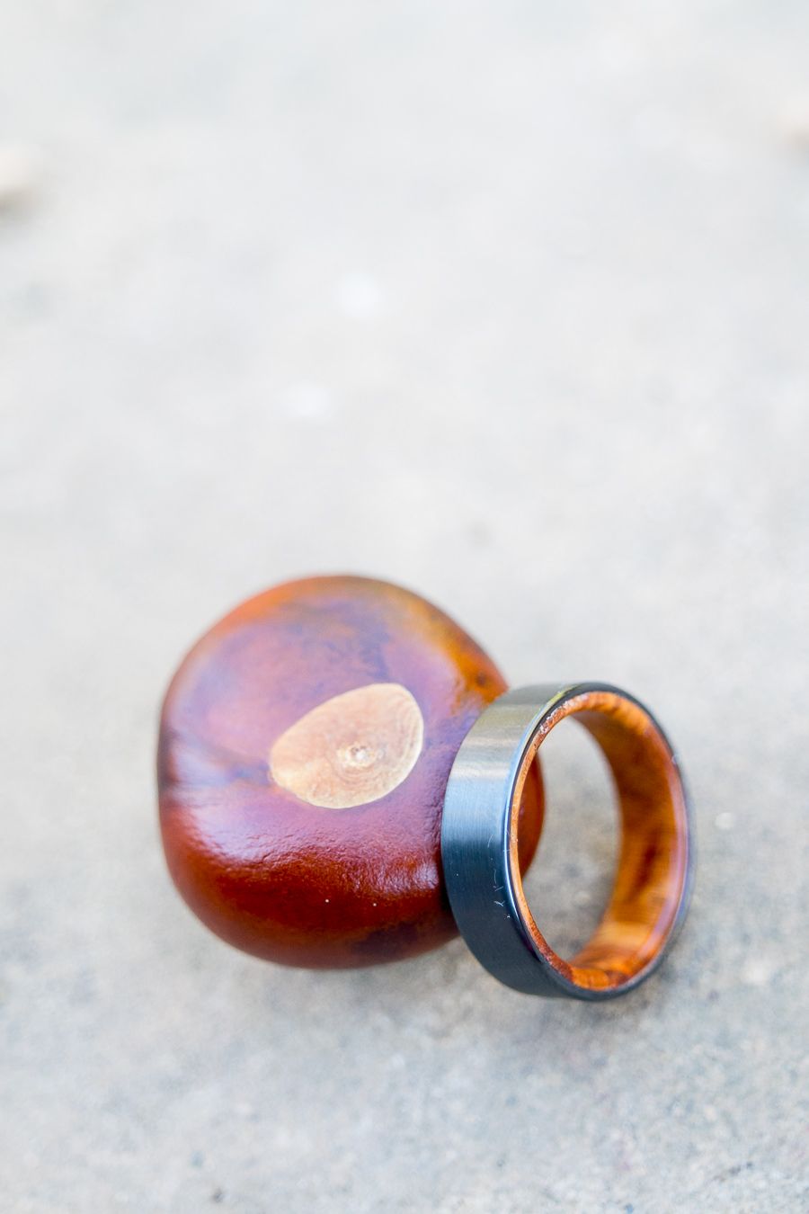 wedding ring with wood interior next to a buckeye