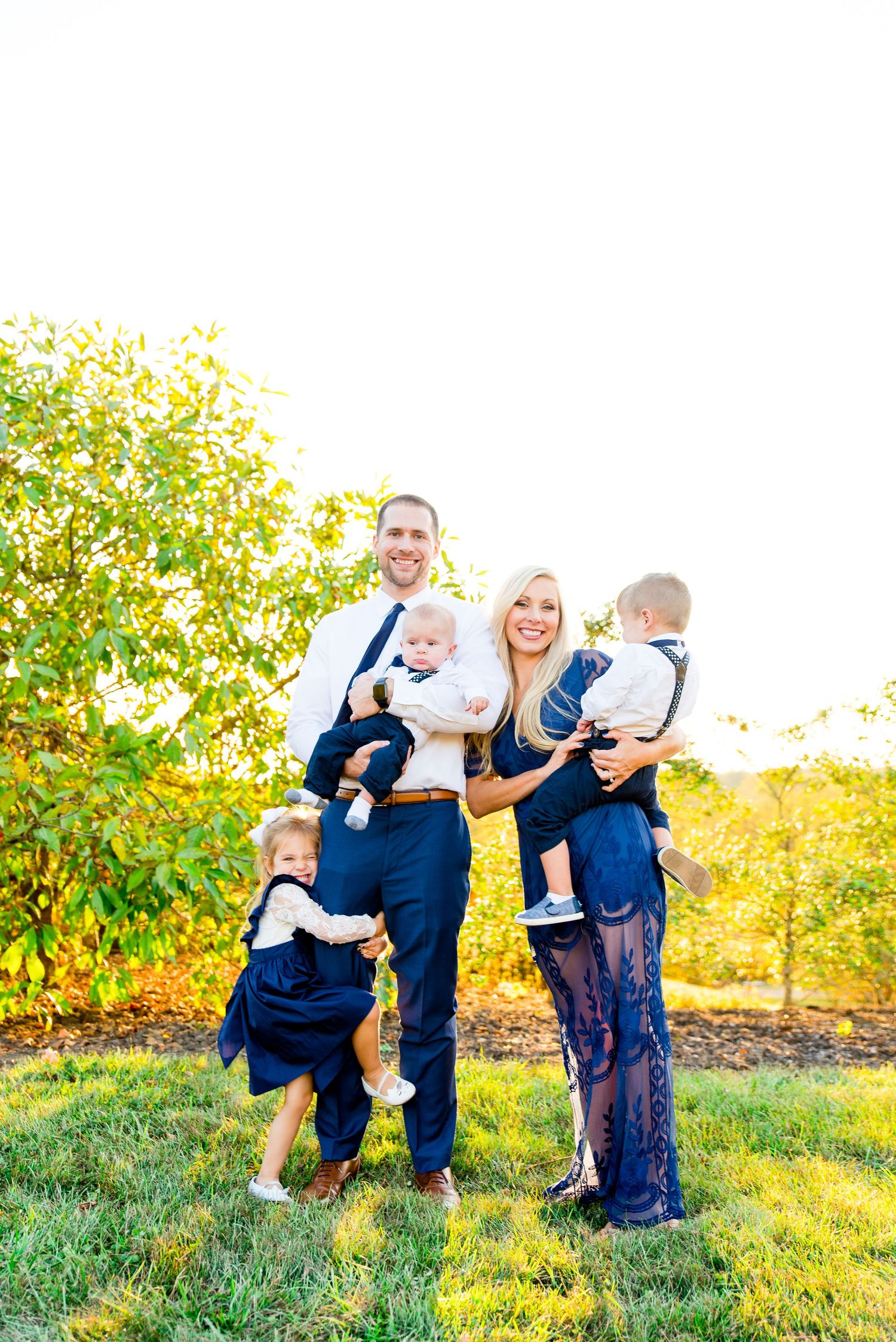 family of five in navy and white smiling at sunset in Grant Park