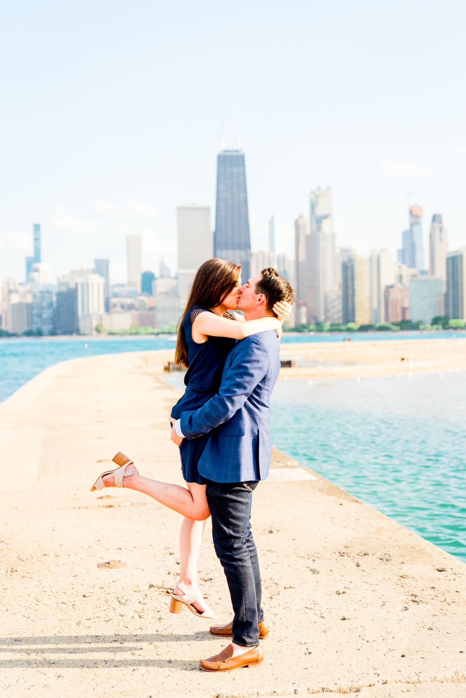 man and woman kissing in front of Hancock tower after North Avenue Beach proposal
