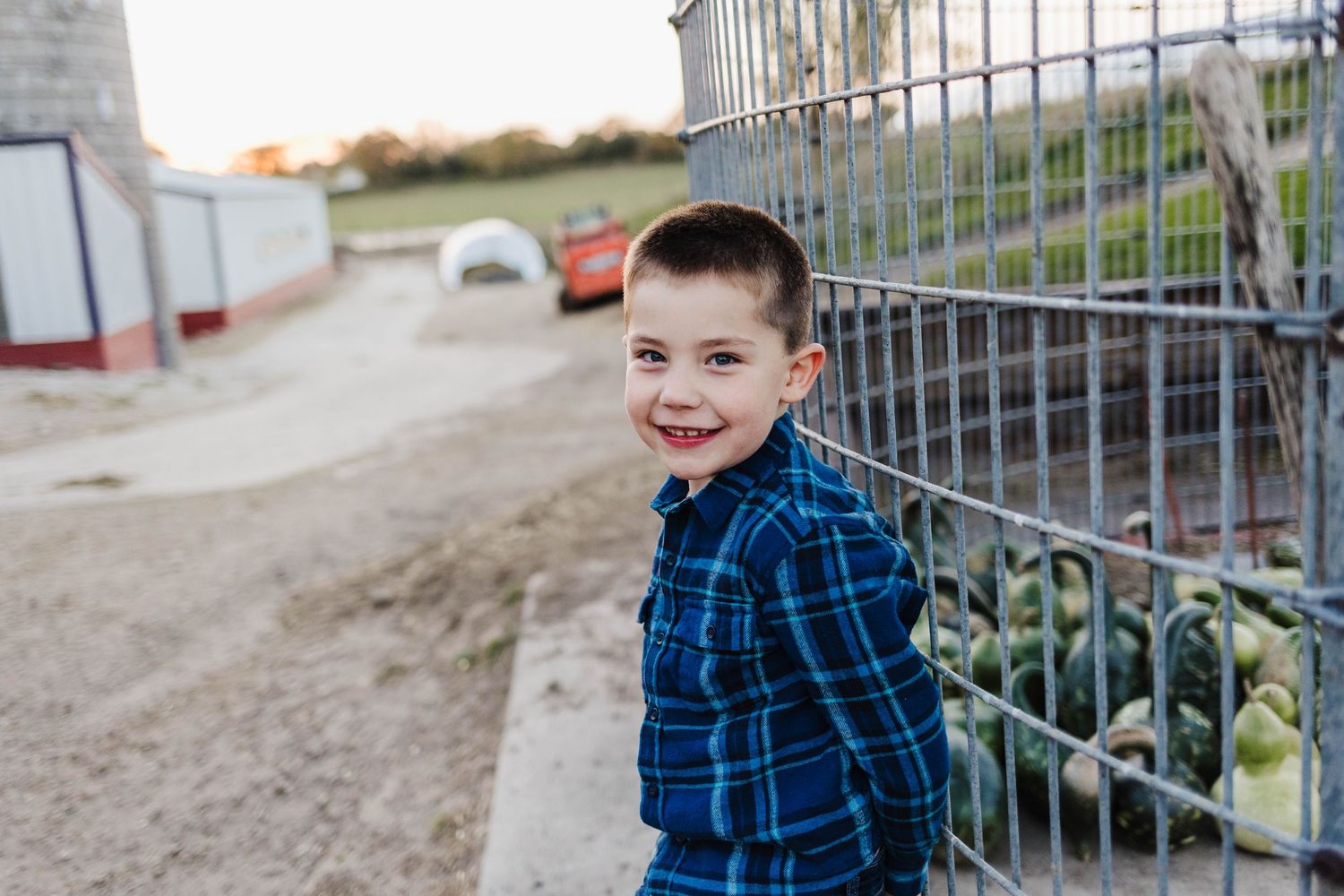 Cute little boy looking at smiling at camera at a family photoshoot cozy nook farm wales wisconsin
