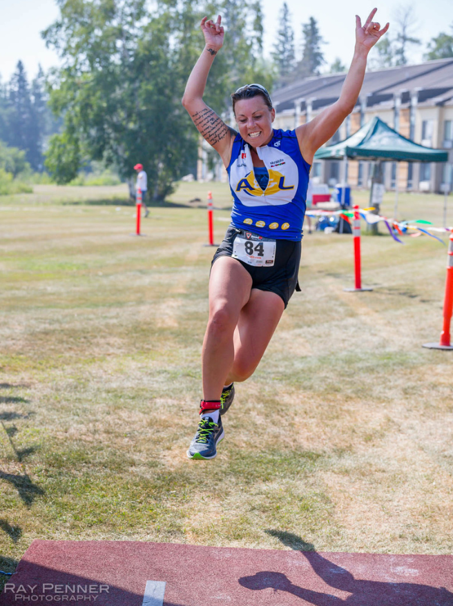 triathlon girl at finish line hands in air Hecla Manitoba Ray Penner Photography