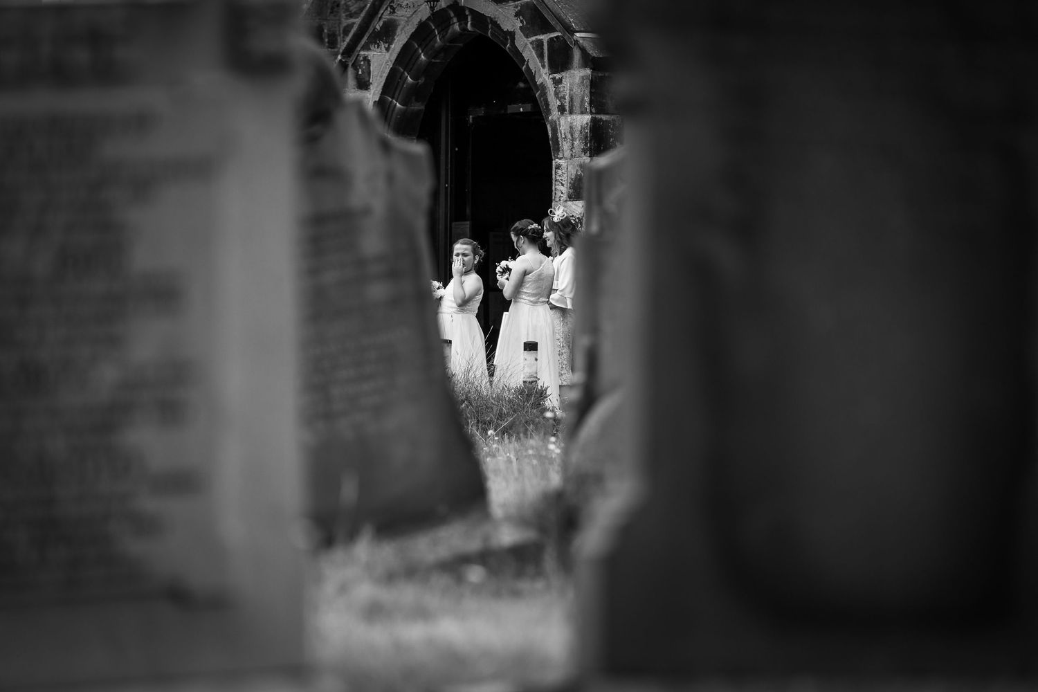 Flower girl stand outside the church photograph taken between gravestones