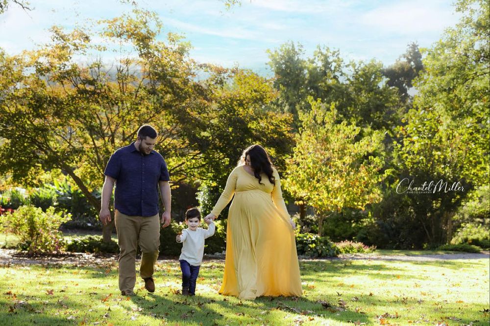 Maternity family walking hand in hand