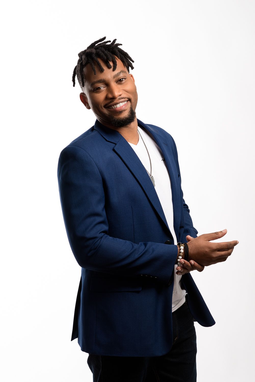 A relaxed business portrait of Logan C Thomas' client in studio against a plain white background.