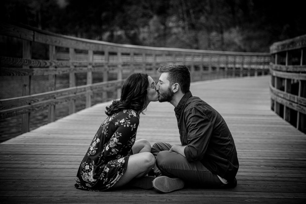 couple sitting on a bridge
