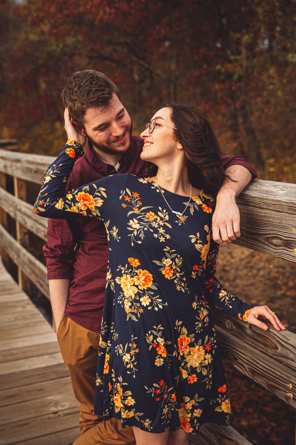 romantic embrace leaning on a bridge