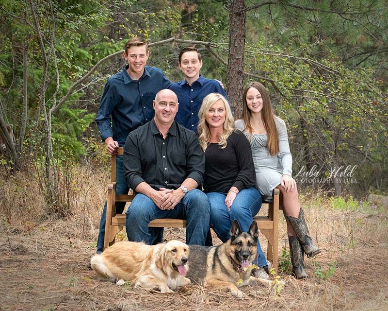 family of five with two gods in a natural wood setting in Post Falls photographer Luba Wold