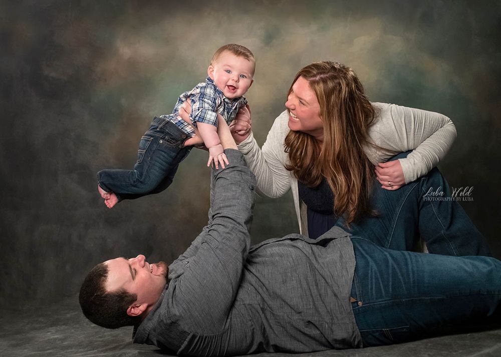 post falls Idaho studio family of three playing with a baby photographer luba wold