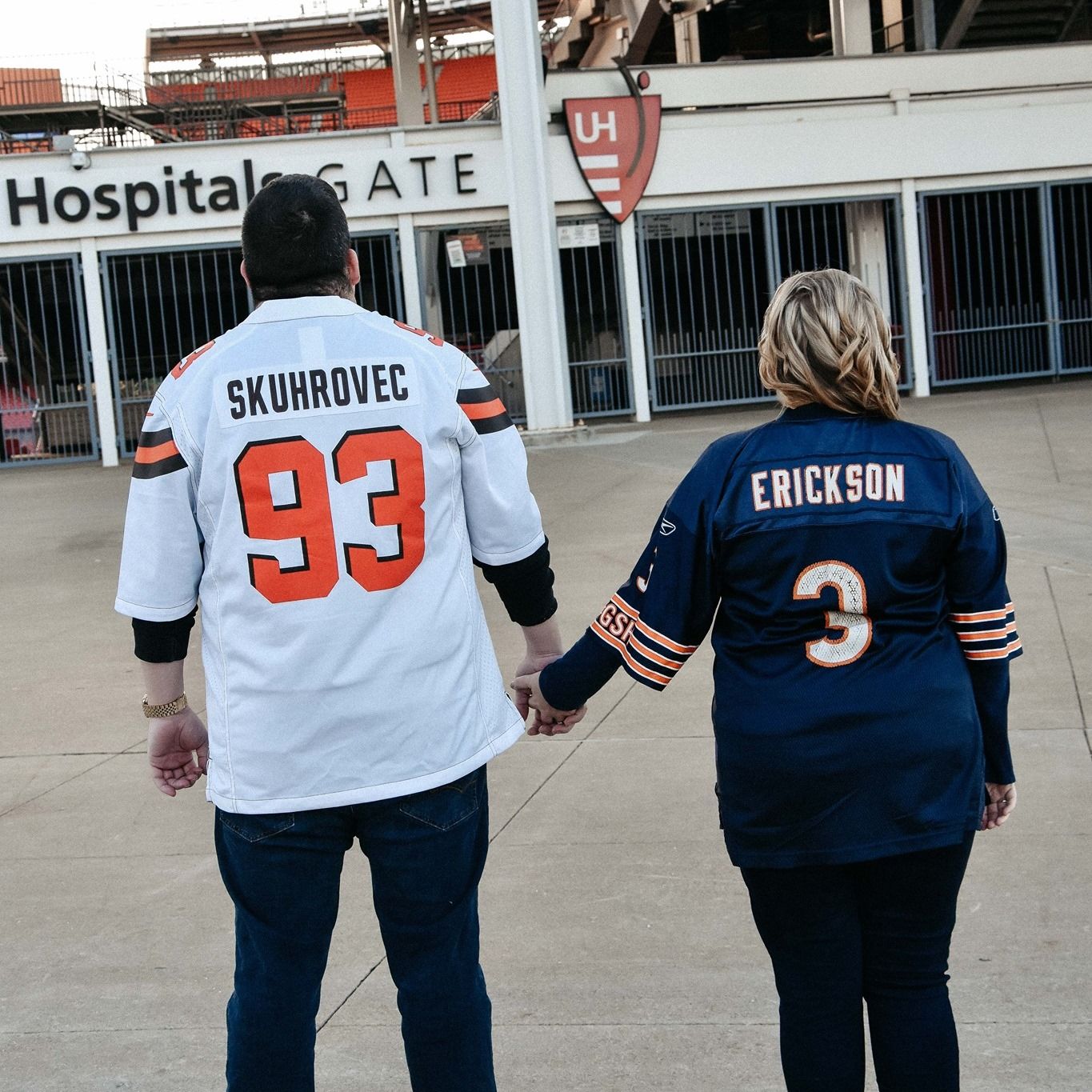 couple stands in front of the Cleveland Browns Stadium