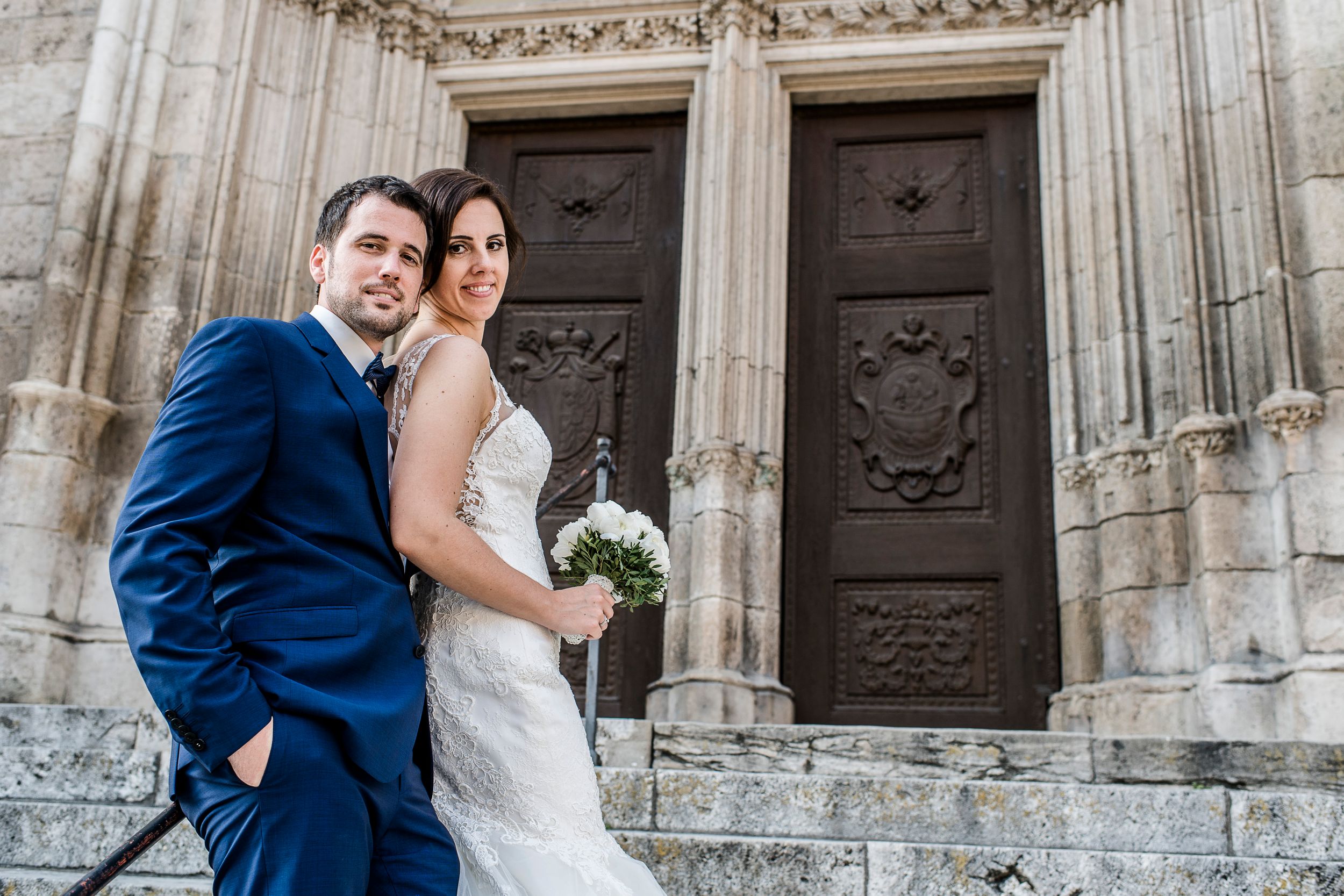 Brautpaar posiert beim Fotoshooting auf den Treppen vor dem Regensburger Dom - Hochzeitsfotoraf Regensburg