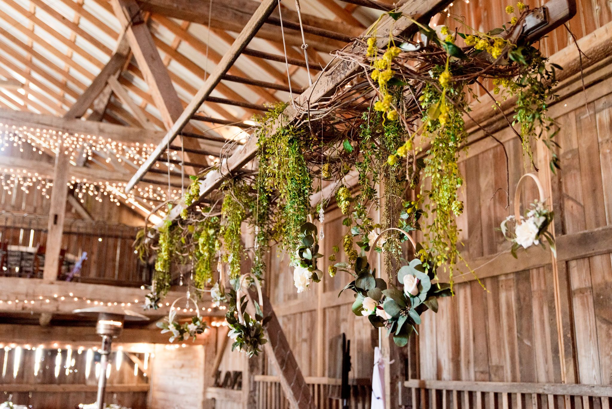 hanging greenery from ladder at Shepard's Place barn wedding venue in Ohio