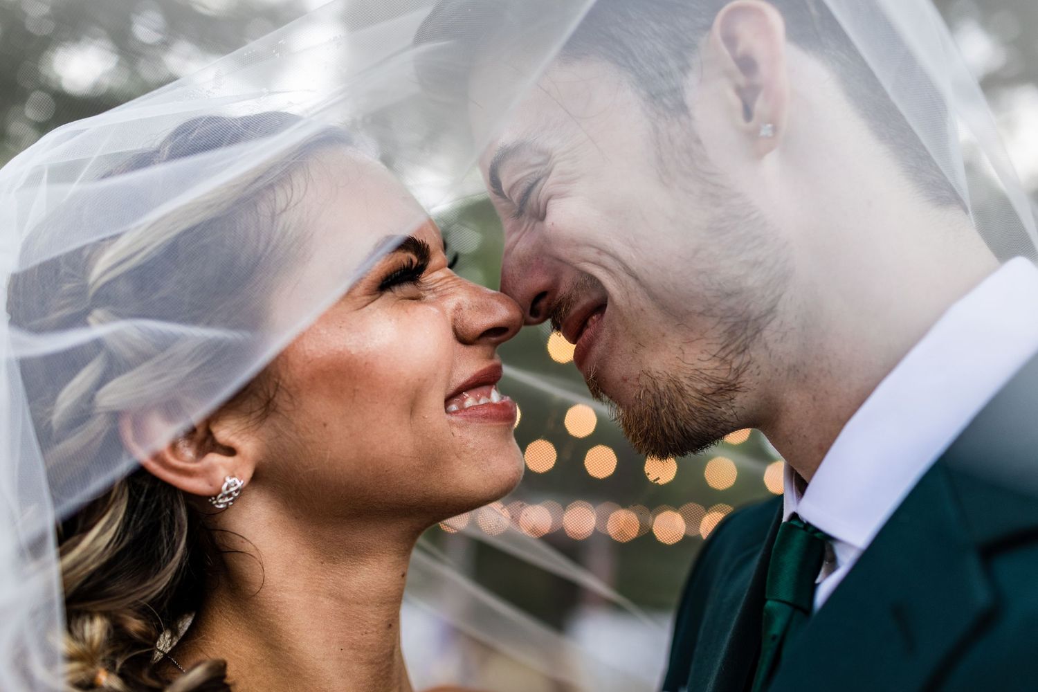 young couple pose under large oak tree at soire estates for intimate wedding ceremony taken by tampa photographer