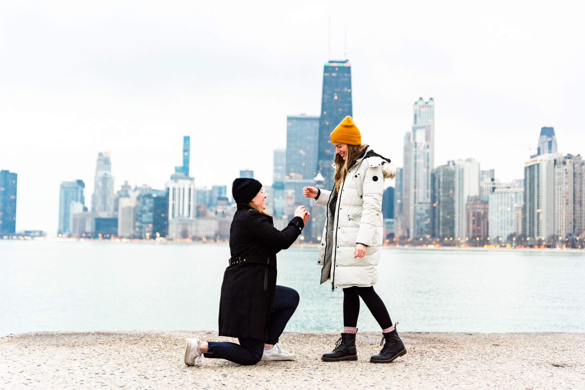 one woman on one knee proposing to girlfriend for Chicago proposal at North Avenue Beach
