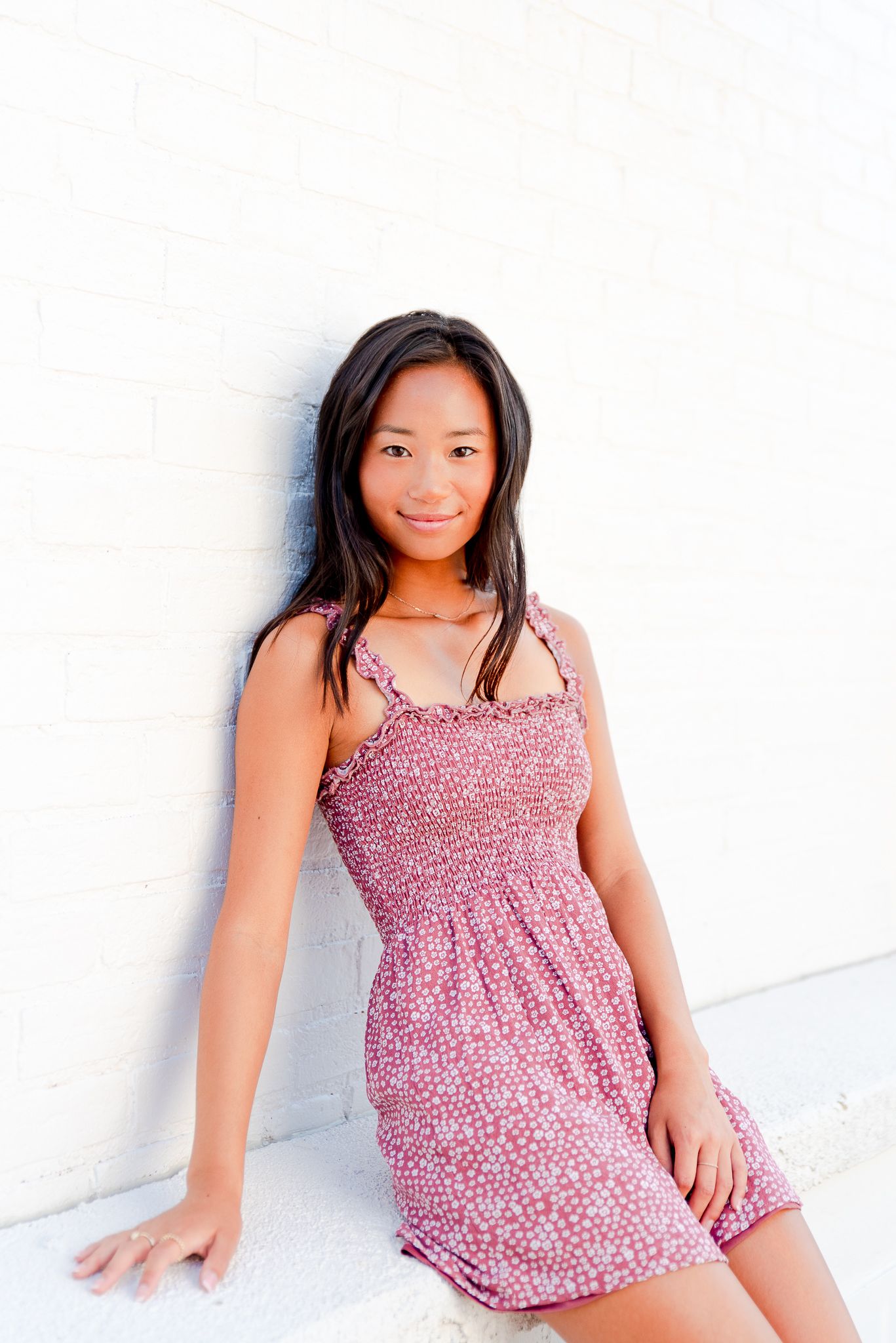 high school senior girl in Chicago leaning against white wall