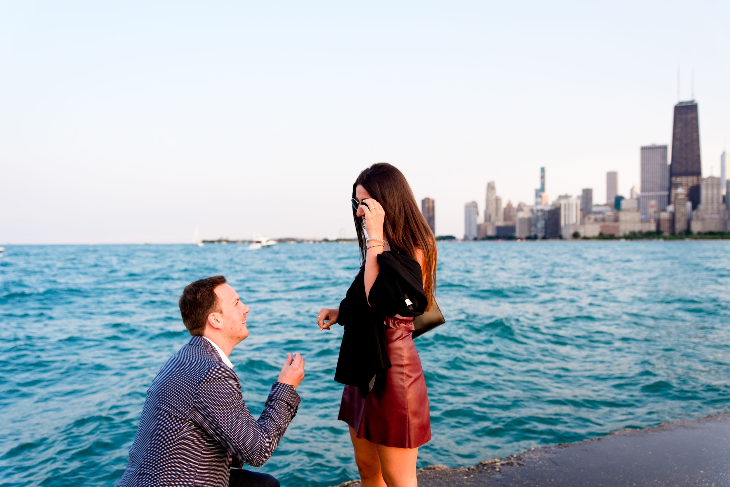 man in gray suit down on one knee for North Avenue Beach Chicago proposal