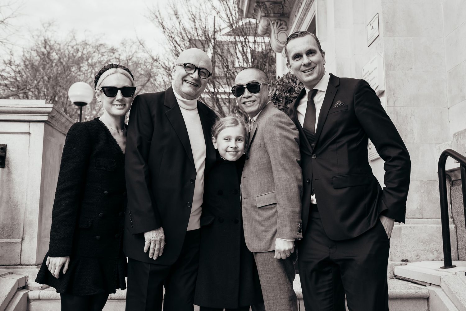 Gay newlyweds and their family standing in front of Islington Town hall, London.