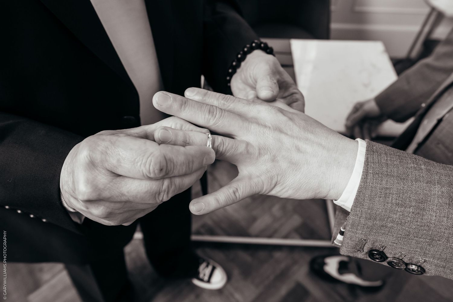 Newlywed gay couple exchanging rings during their ceremony at Islington Town Hall in London