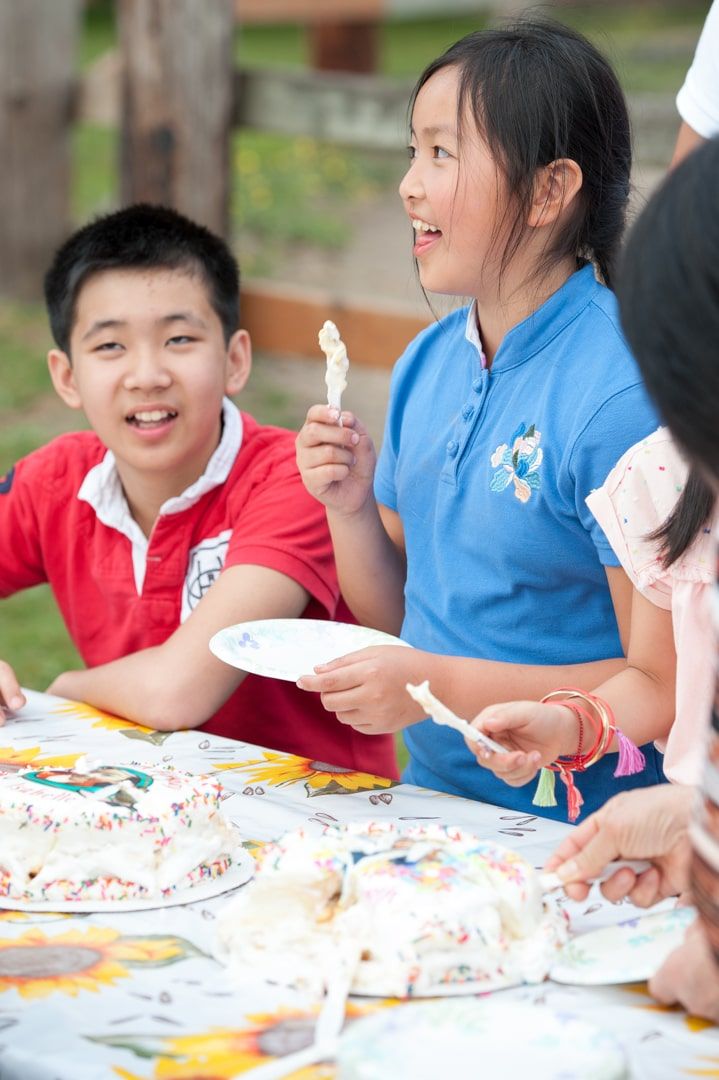 birthday girl eating cake at party