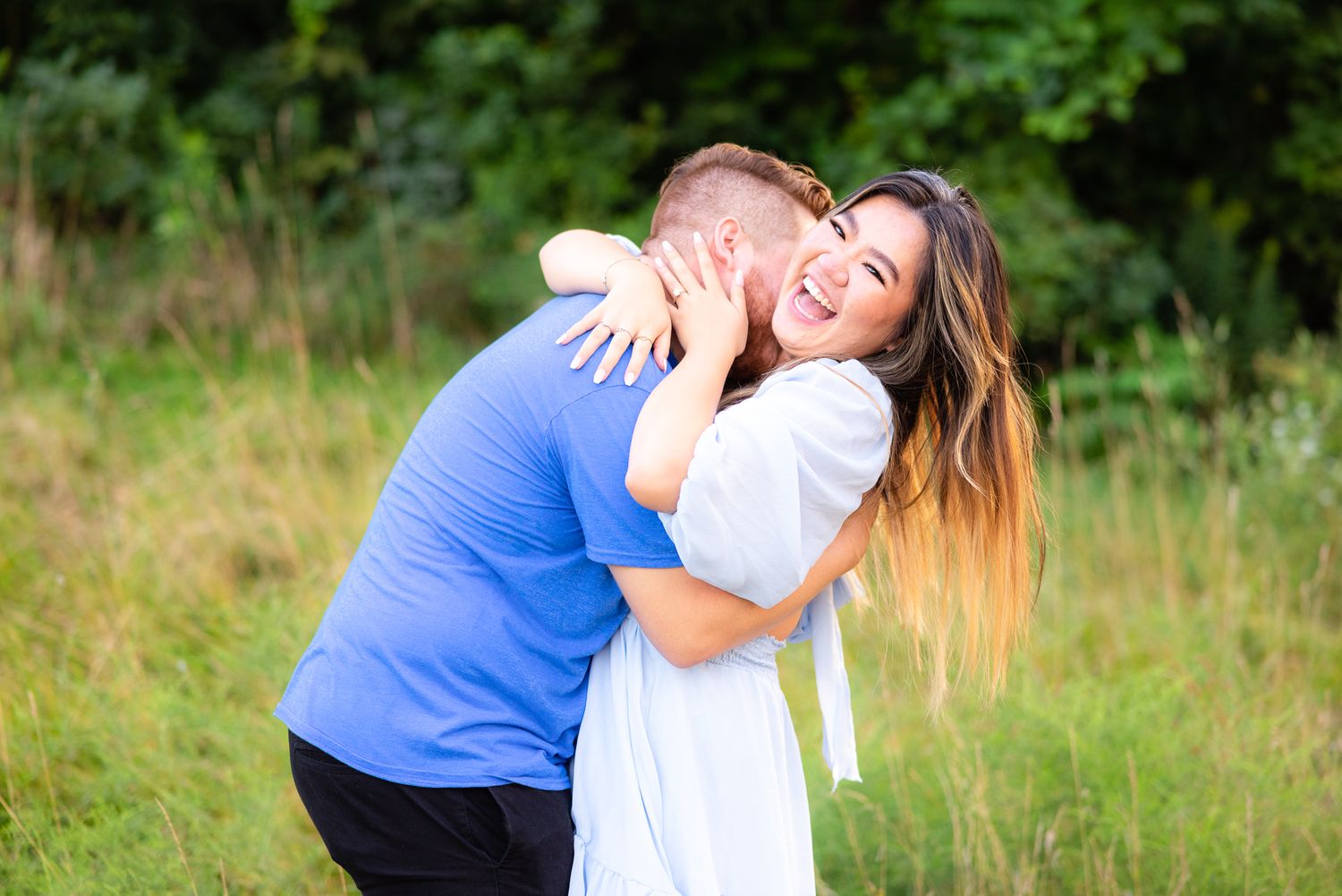Couple Laughing and Having Fun During Engagement Photo Session at Edgewater Park Beach in Cleveland, Ohio