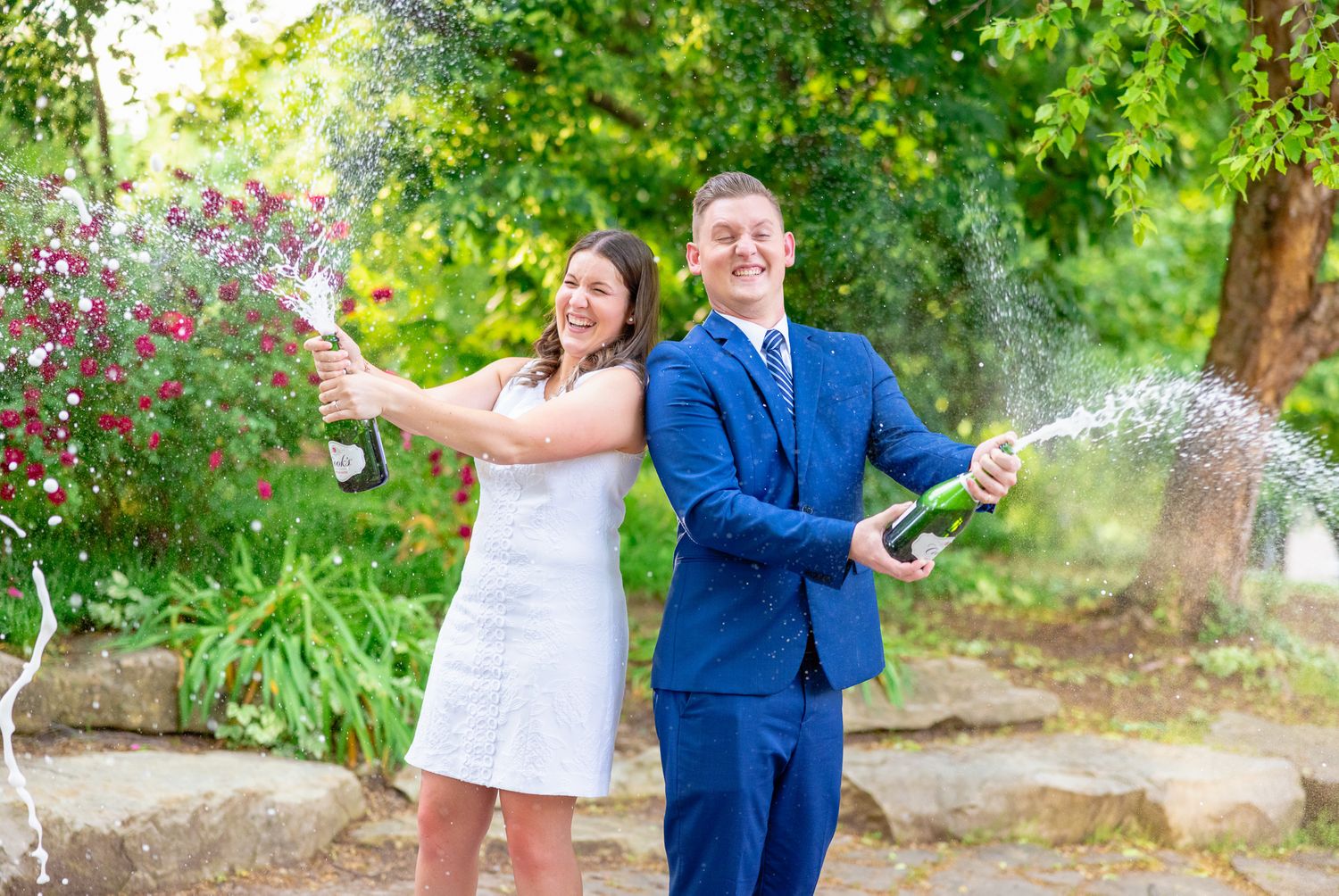 Engaged Couple Spraying Champagne During Engagement Session