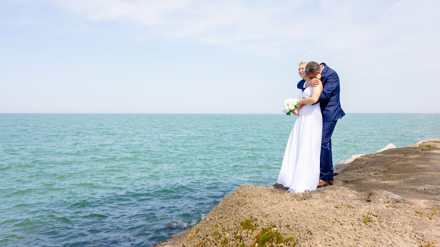 Wedding Photo of Couple Overlooking Lake Erie During Wedding in Huron, Ohio