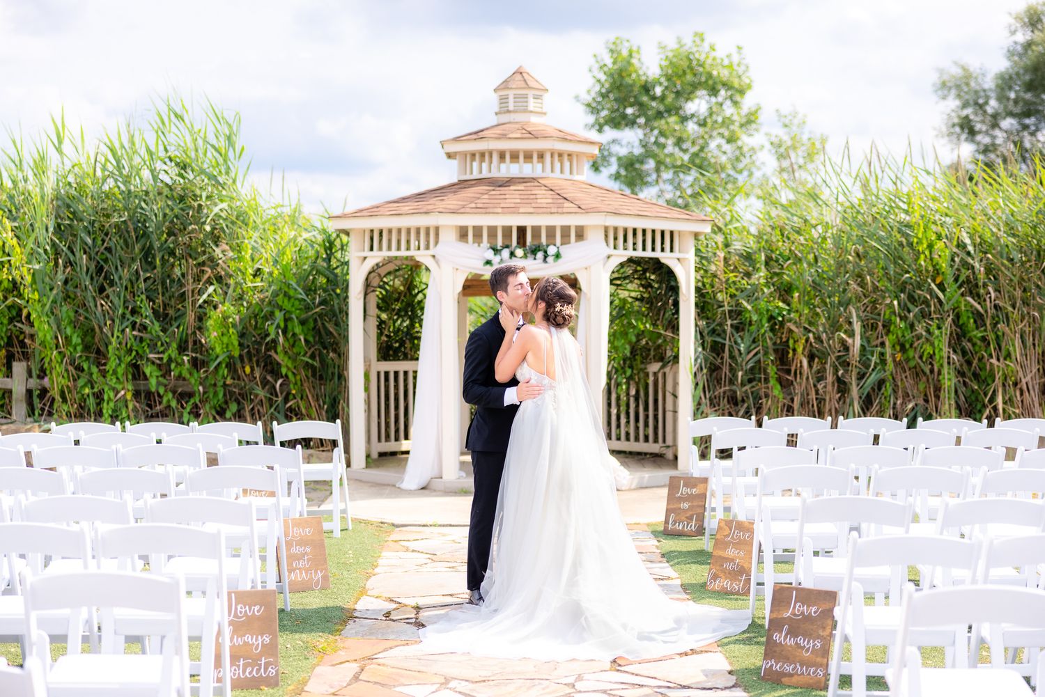 Wedding Photography of Couple Kissing in Front of Gazebo During Wedding at White Birch Barn in Medina, Ohio