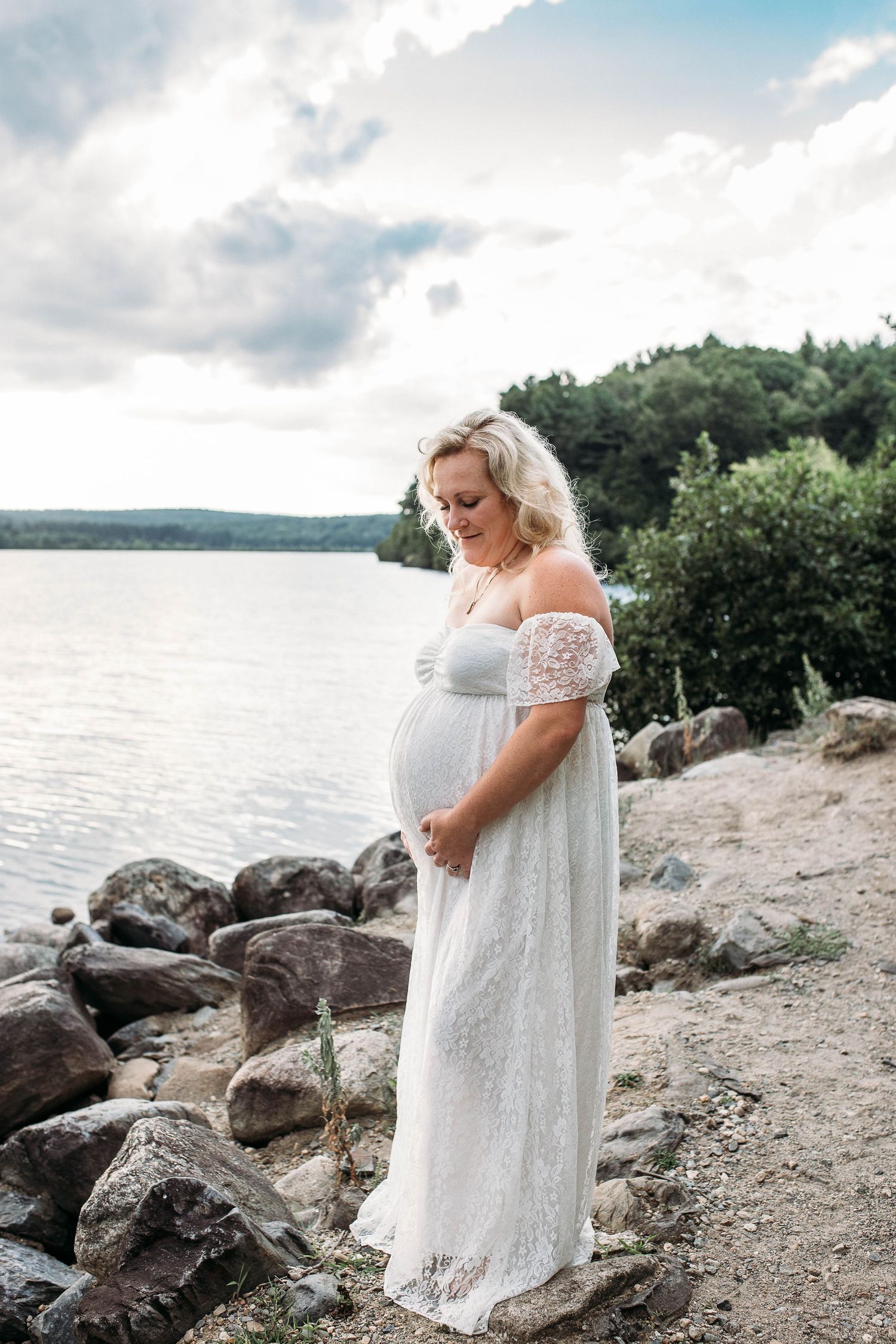 pregnant woman by the lake by worcester maternity photographer