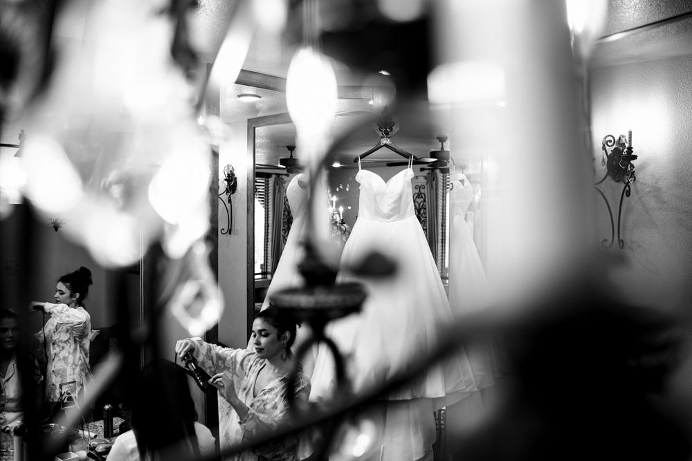 Wedding dress hanging by mirror