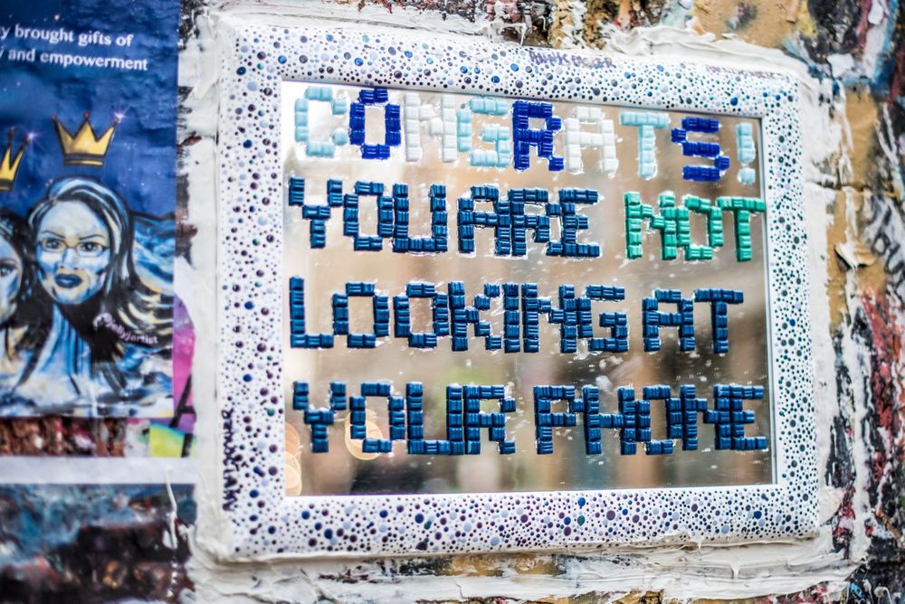 Congrats, you are not looking at your phone mirrored message on wall in London's artsy Shoreditch area.