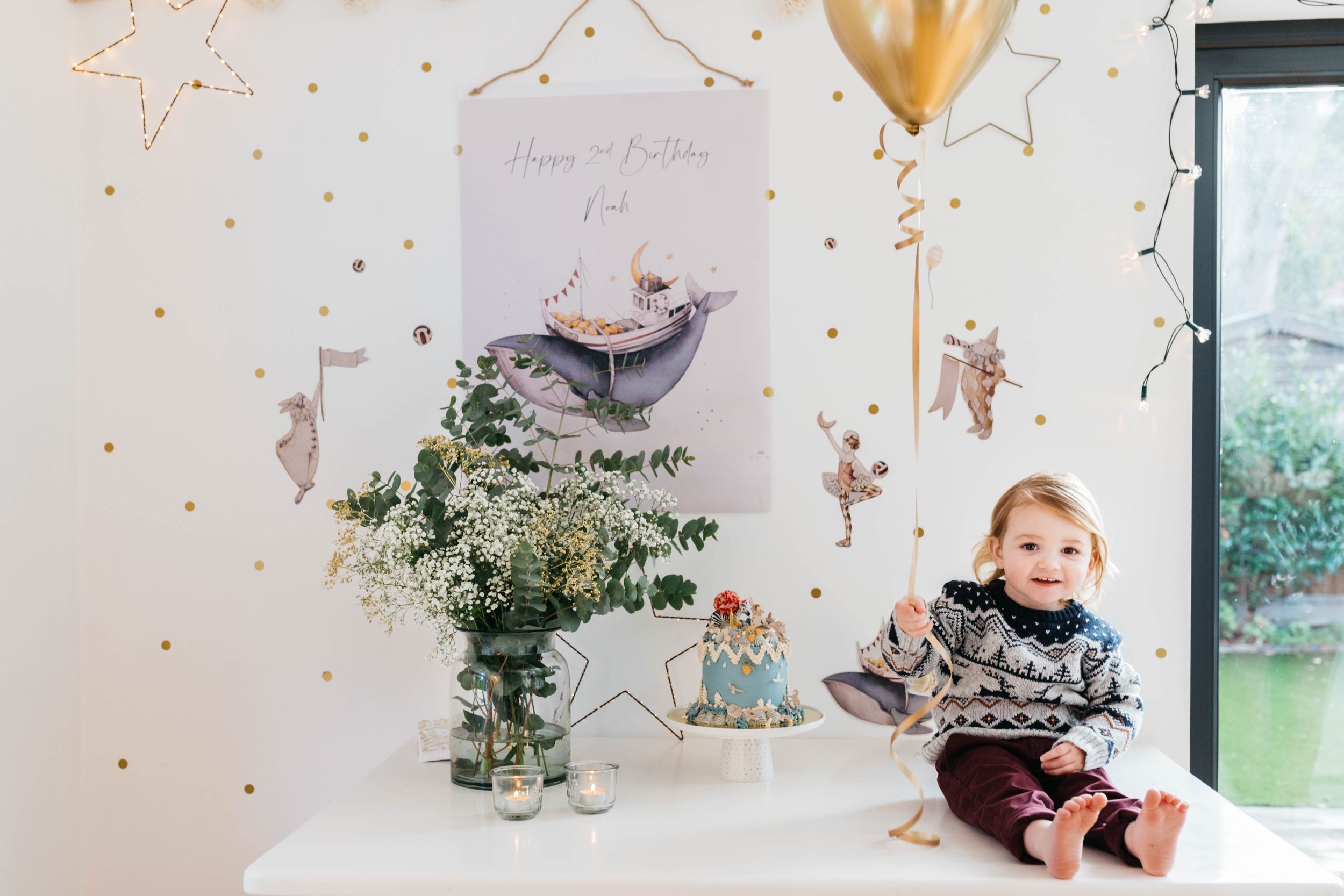 winter birthday photo session two year old with balloon