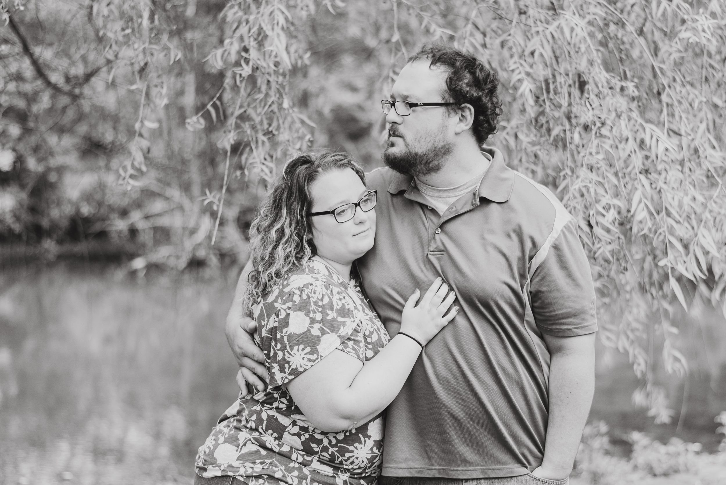 Couple standing under willow tree in black and white at Succop Conservancy in Butler Pennsylvania