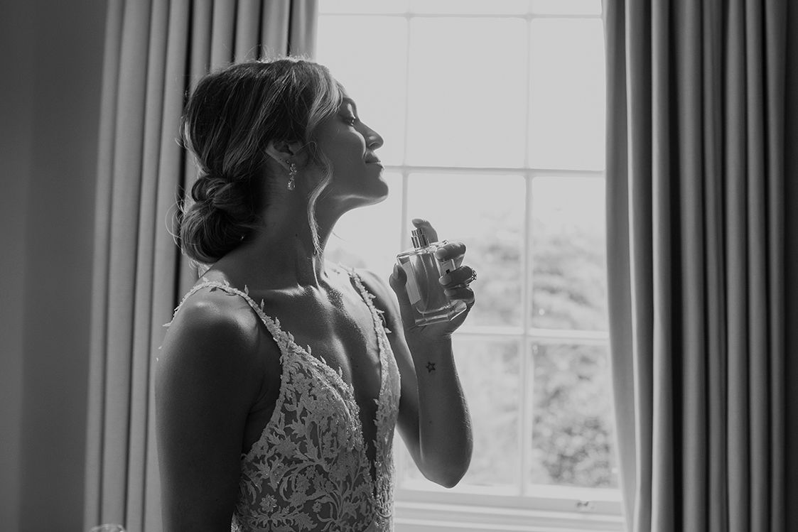 Bride sprays Jo Malone perfume on wedding day