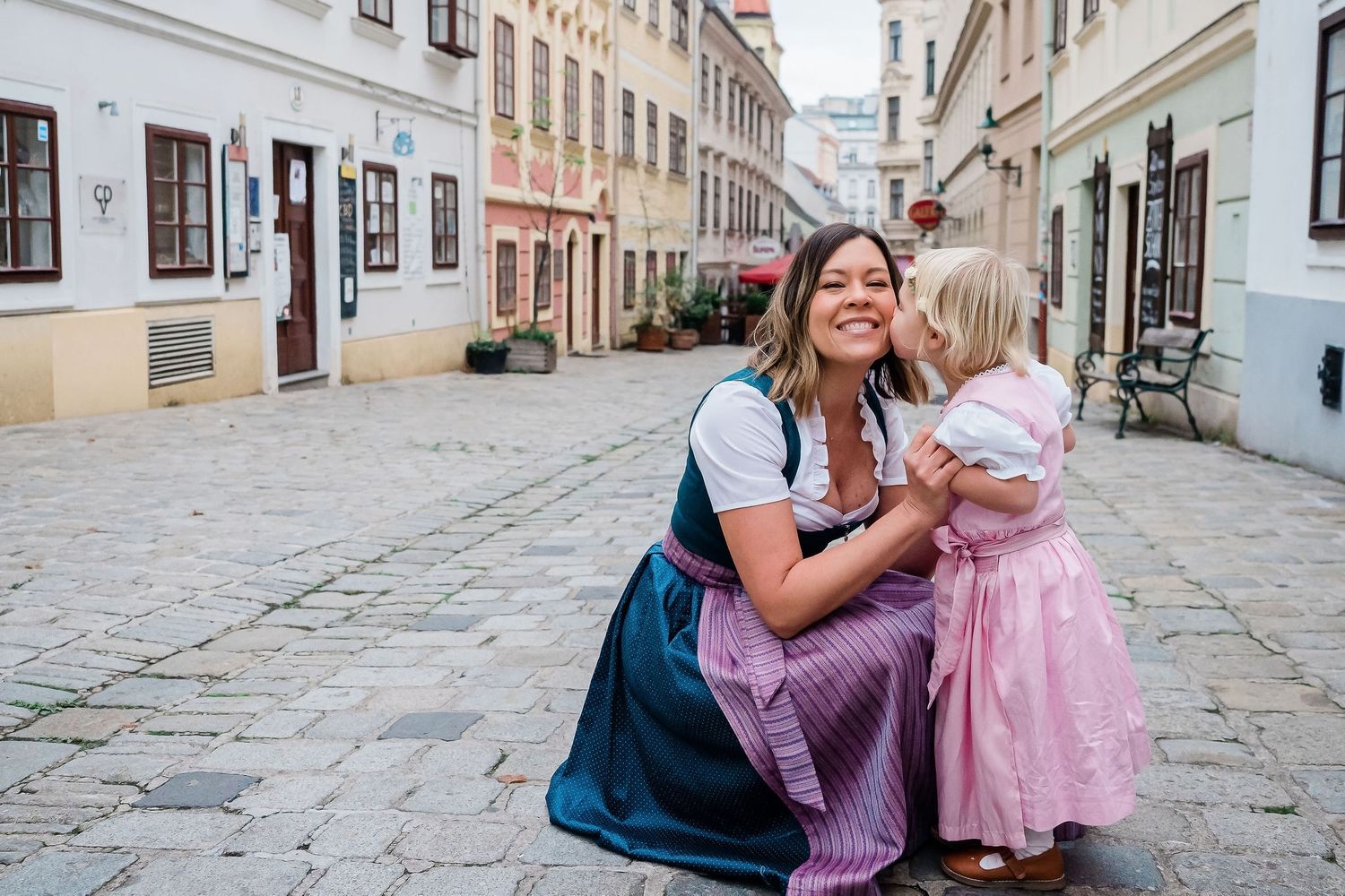 Mother and daughter in a street in Vienna wearing traditional outfit Dirndl