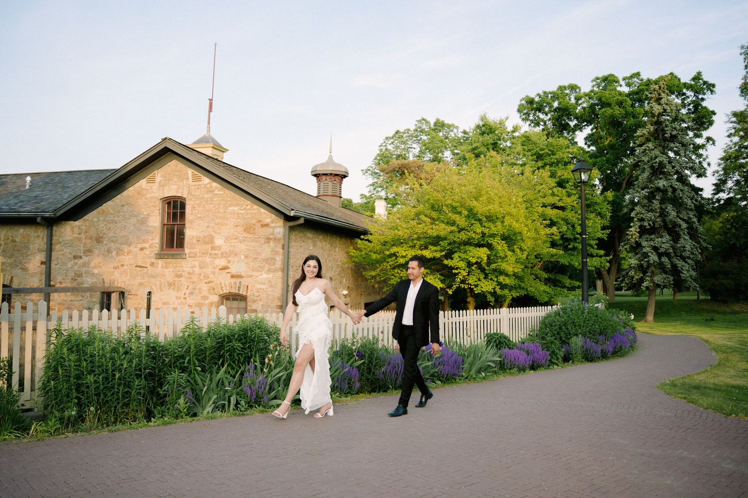A collage of outdoor wedding photos with garden and historic stone building views.