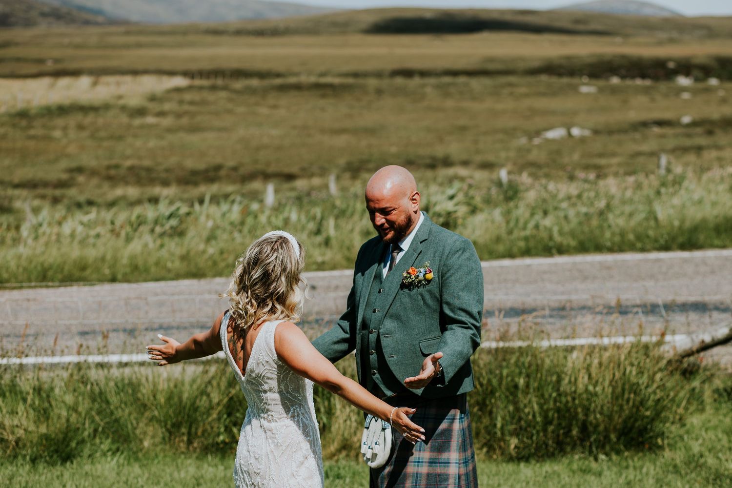 Scottish Highland wedding ceremony with couple outdoors in beautiful mountainous landscape.