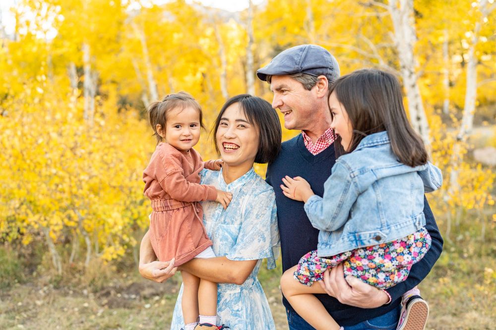 Family laughing with each other in nature at a spot at the Alpine Loop.