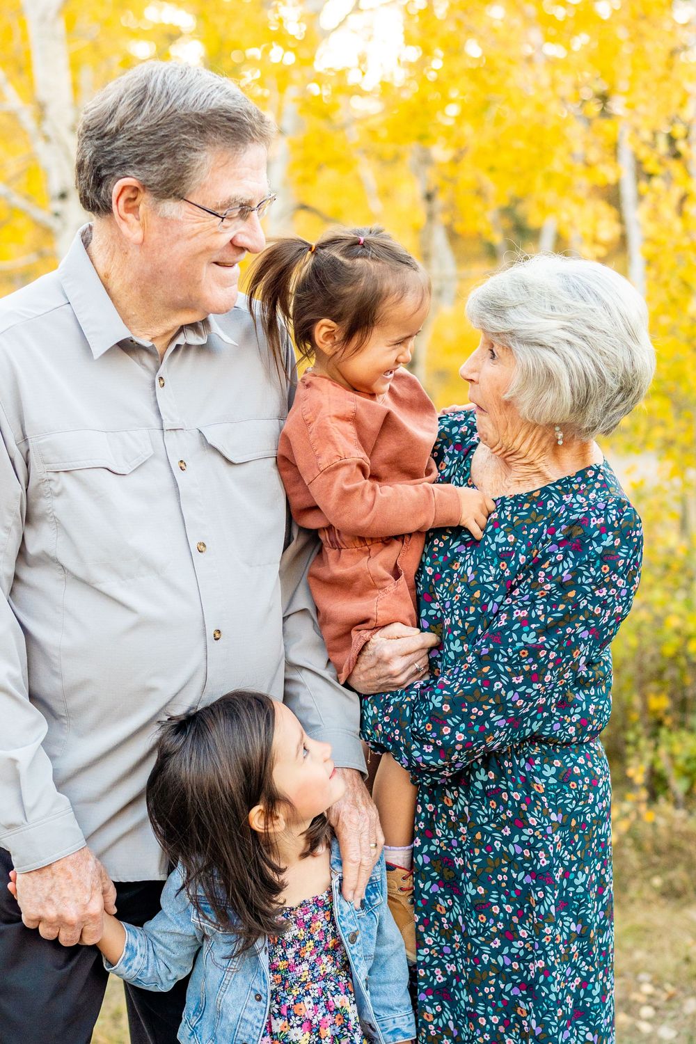 Grandma and grandpa holding toddlers at a spot at the Alpine Loop.