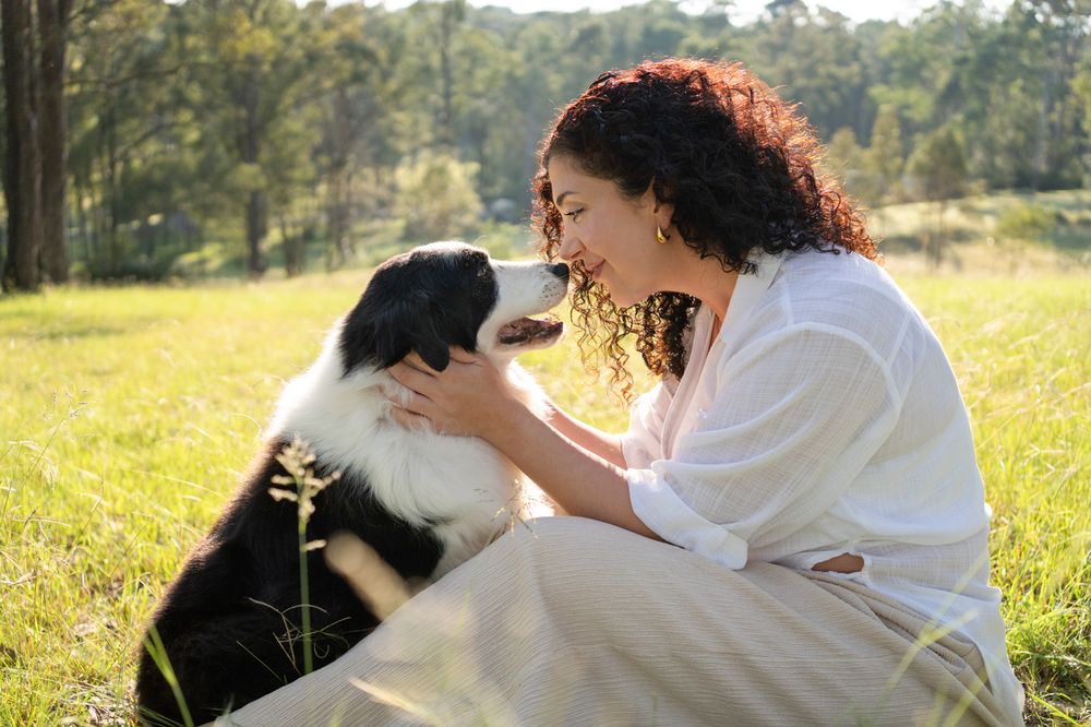 gild softly touching her border collie during an end of life photoshoot in Sydney