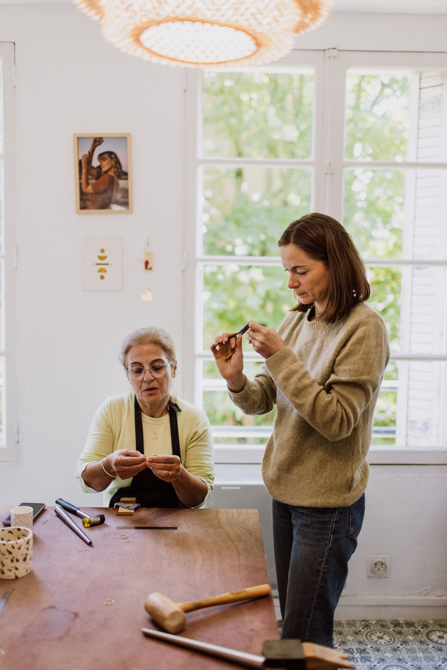 Bright crafting space with warm lighting and large windows overlooking greenery.