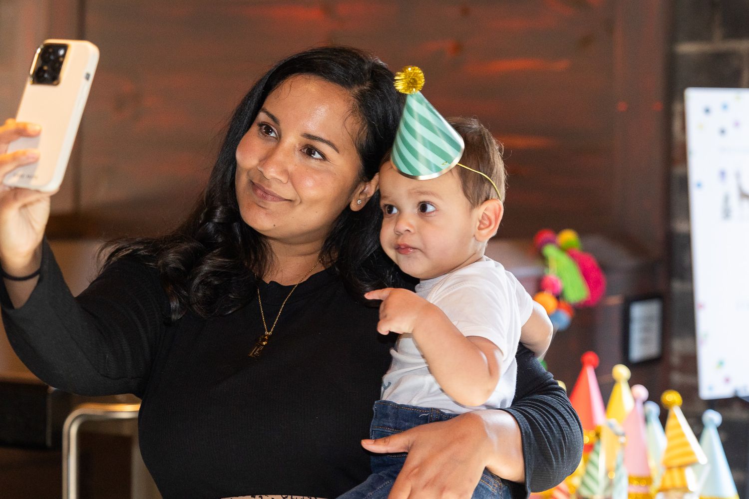 Taking a celebratory selfie during a first birthday party.