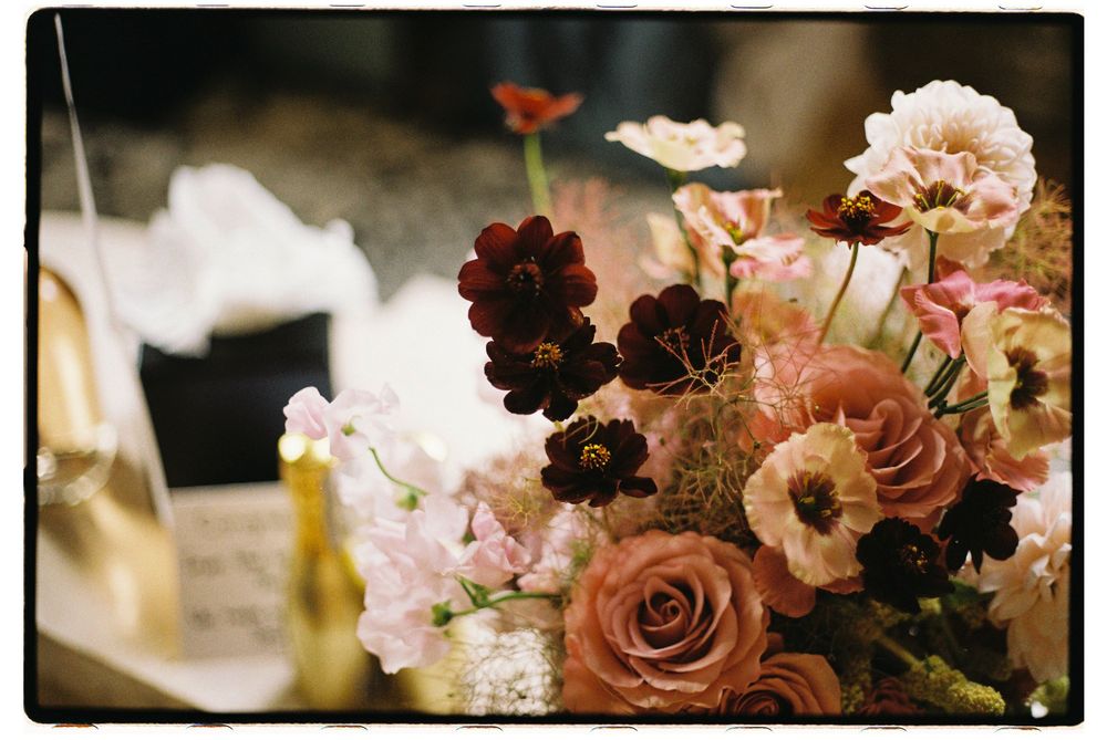 A romantic floral arrangement featuring delicate pink blossoms and mauve roses in a soft, dreamy composition.