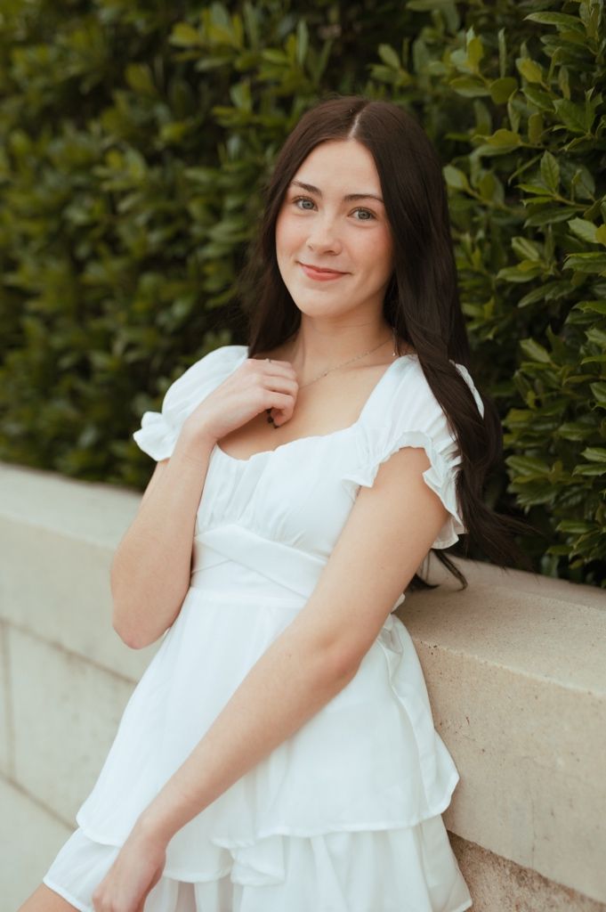 A series of outdoor portrait photos featuring someone in a flowing white summer dress against a garden backdrop.
