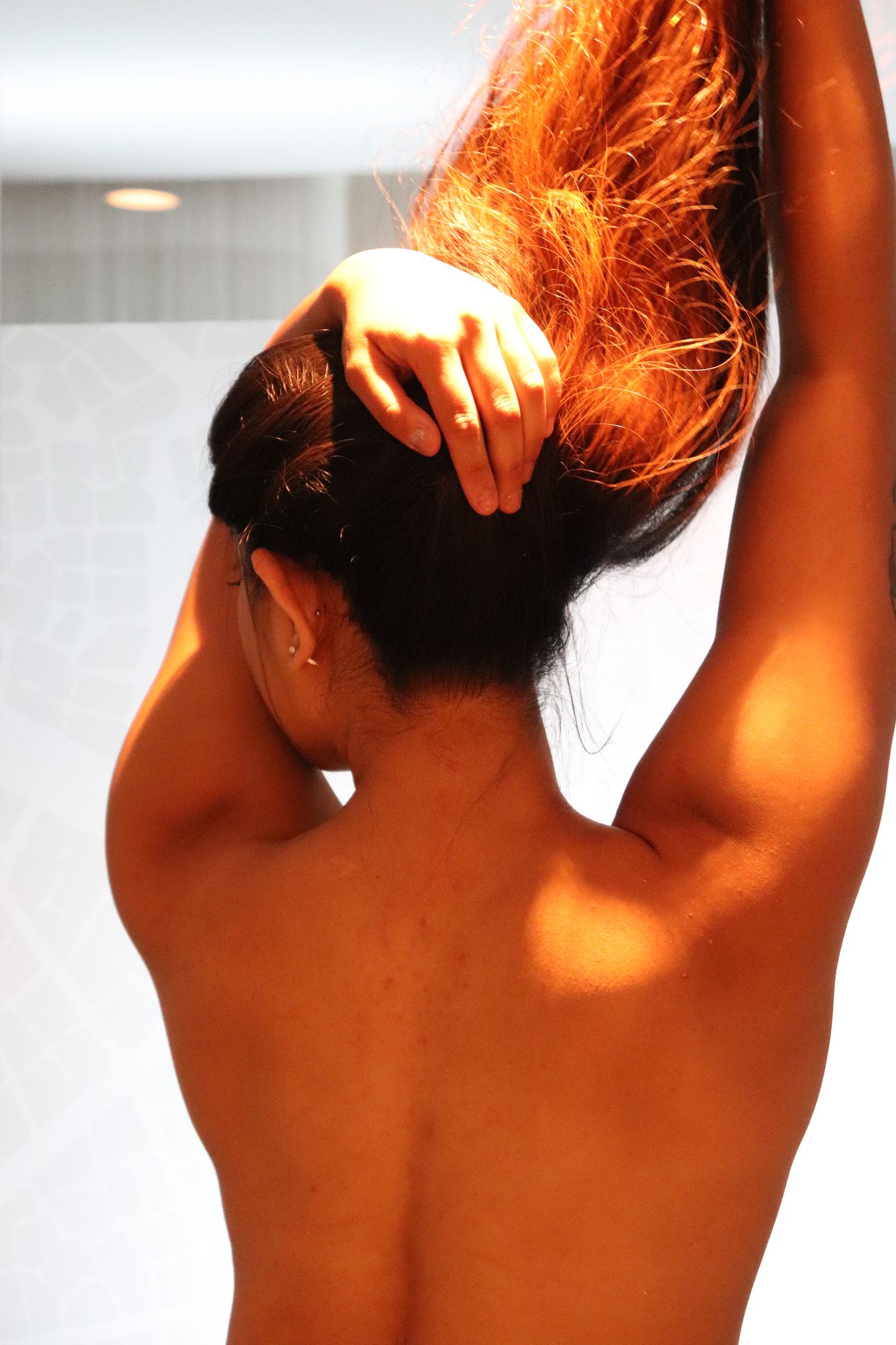 A woman posing for a boudoir photo