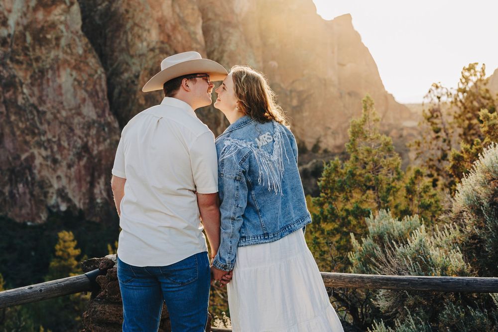A romantic sunset photoshoot against dramatic red rock cliffs and natural scenery.